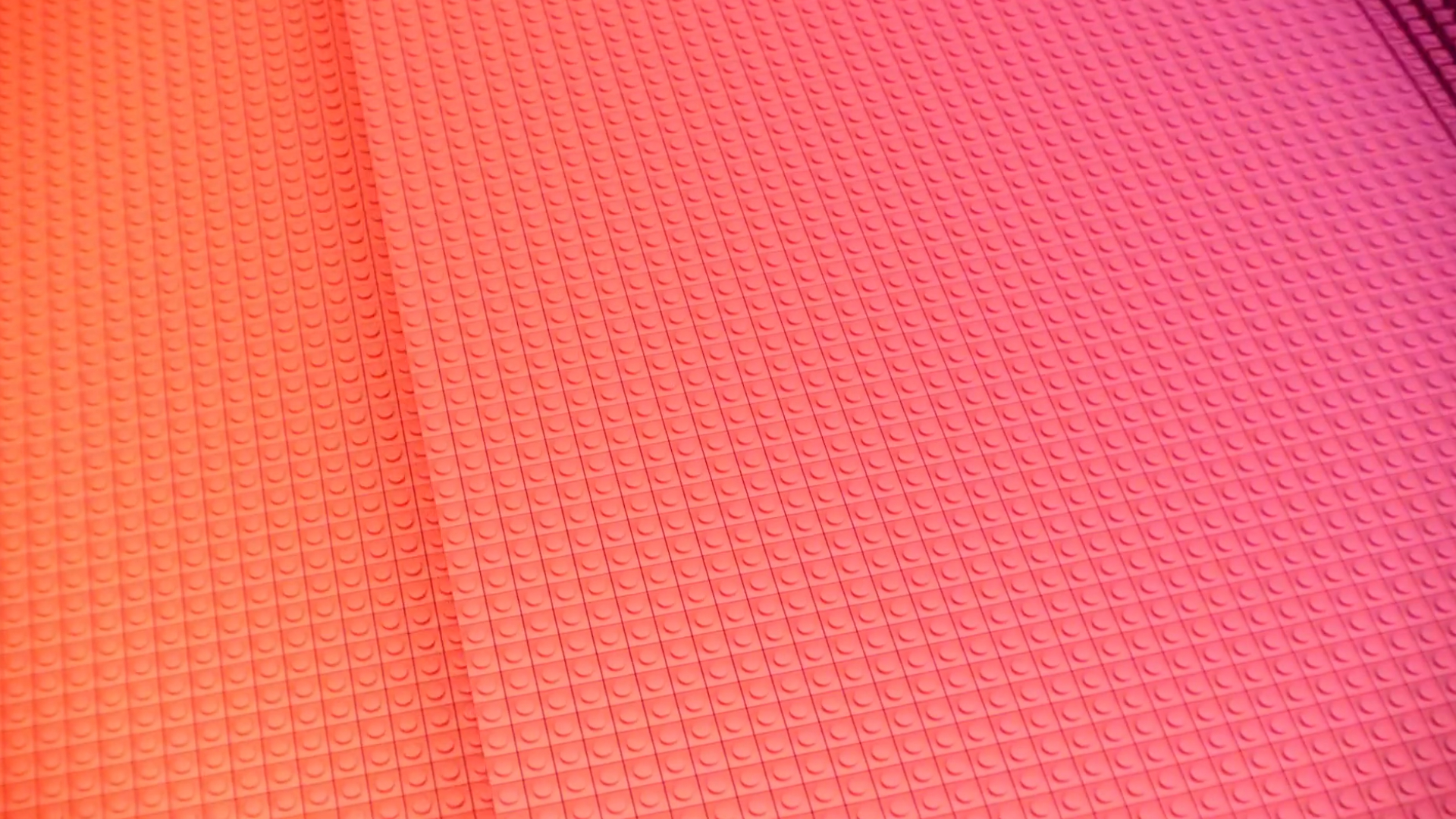 Orange, red and magenta bricks forming the Iren colour gradient in motion