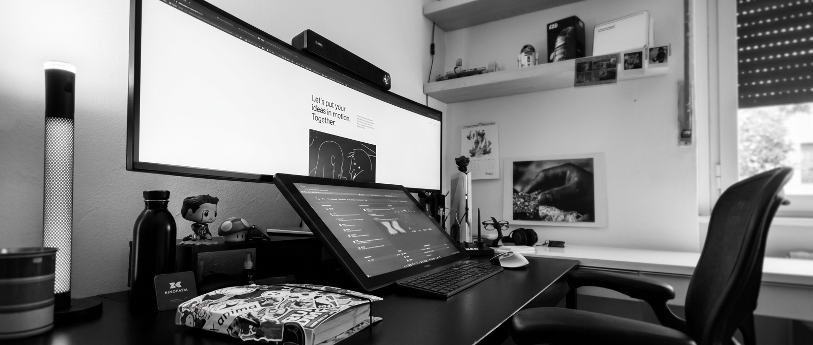 Workspace with an ultrawide monitor and drawing tablet